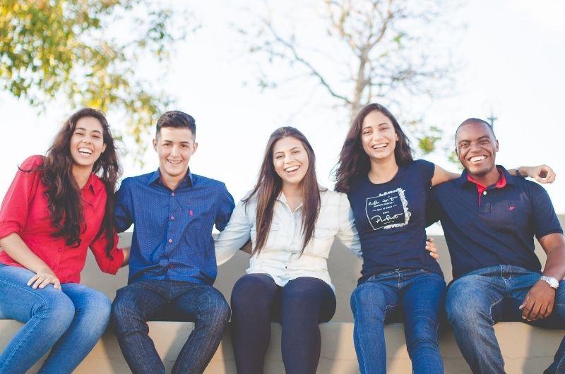 group of students (male and female) huddle together